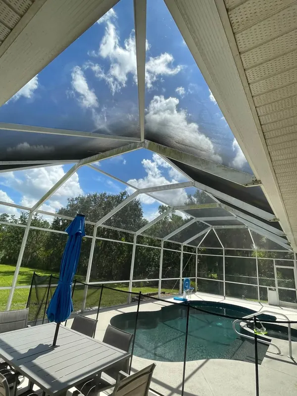 Same pool cage screens clean with clear sky through them