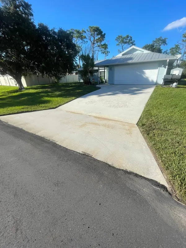 Sloped concrete driveway being cleaned