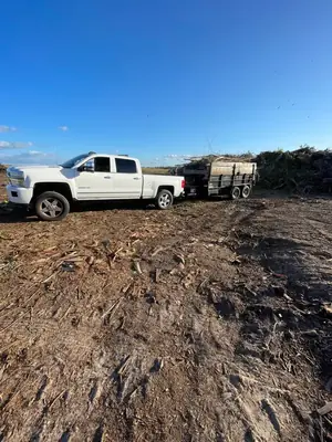Pickup and loaded trailer on a freshly cleared lot