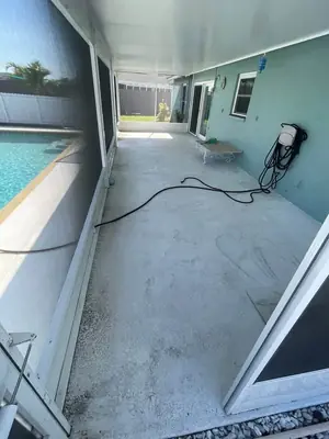 Covered lanai floor stained and dirty before washing