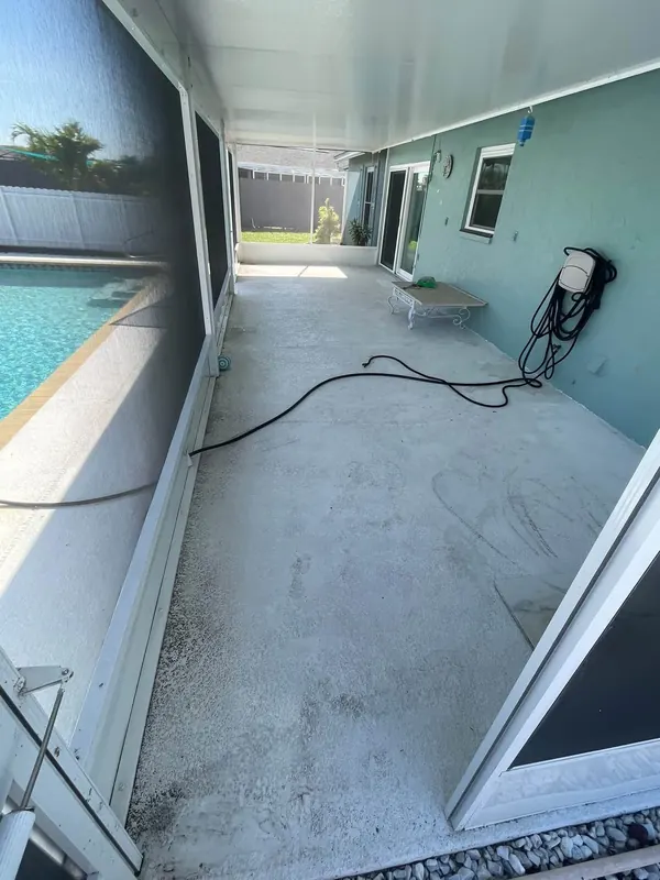 Covered lanai floor stained and dirty before washing