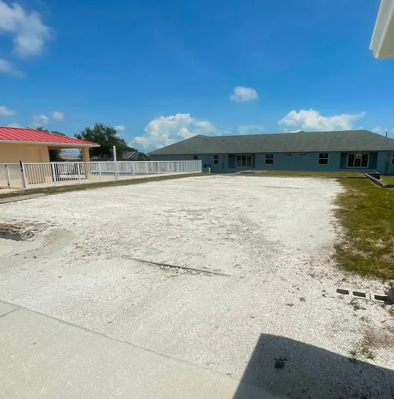 Worn, patchy parking area before new gravel