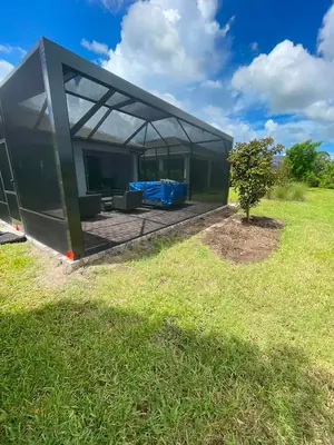 Grass beside a pool cage before a new bed