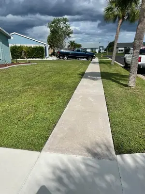 Same front sidewalk clean after pressure washing